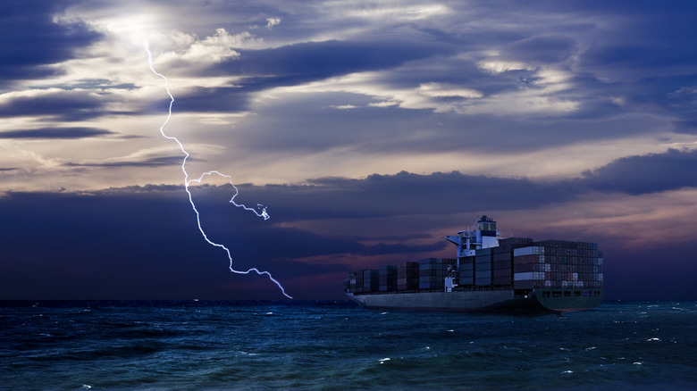 Lightning strike over water with ferry ship nearby