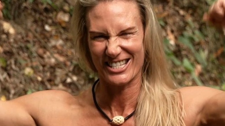 NAked and Afraid contestant flexing arm muscles