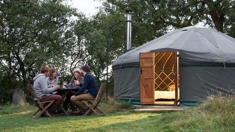 People outside a yurt