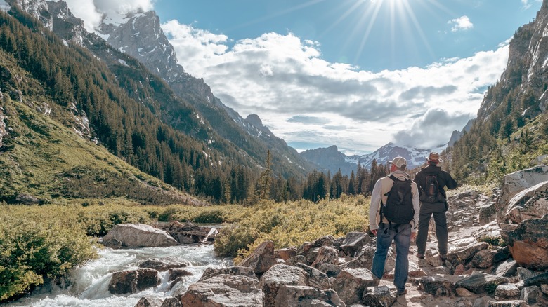 Two hikers gazing at view of Grand Teton National Park