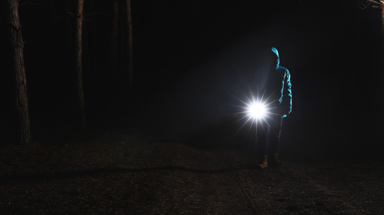 Hiker signaling with flashlight