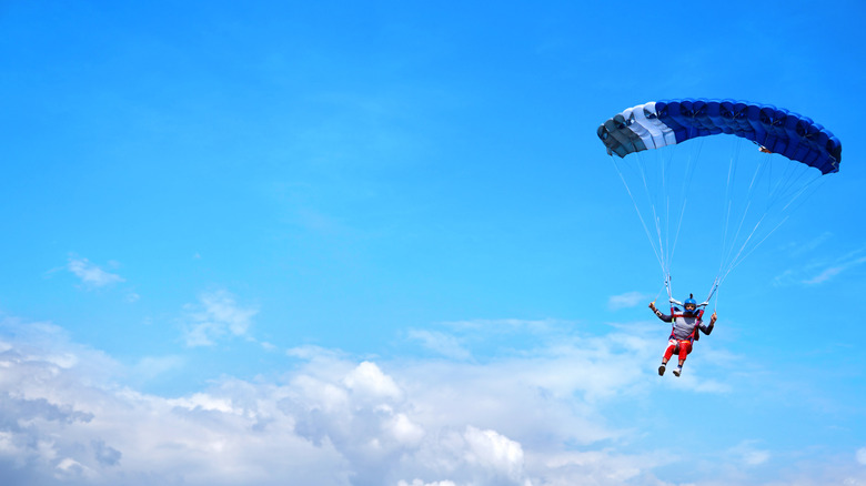 Skydiver with blue parachute