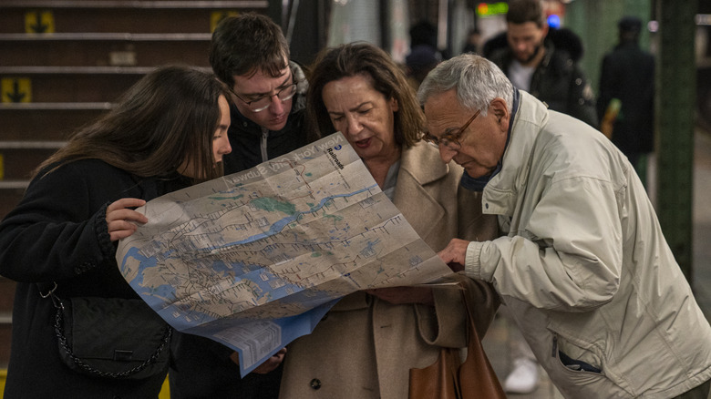 Tourists looking at map inside metro station
