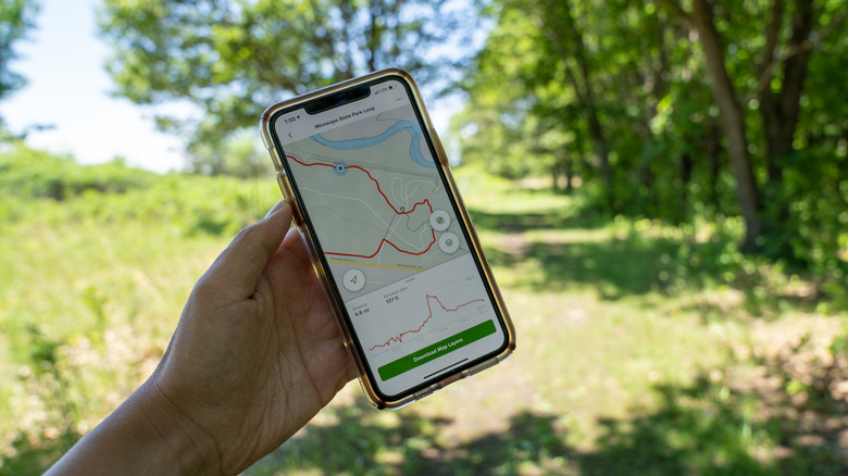 Person using AllTrails while hiking