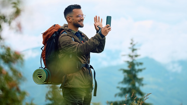 Man on phone while hiking