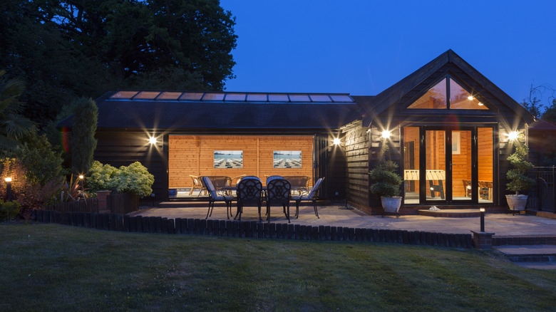 Dark-colored patio at night with lights on