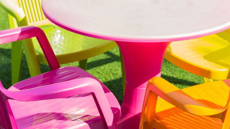 Neon chairs and table outside on grass