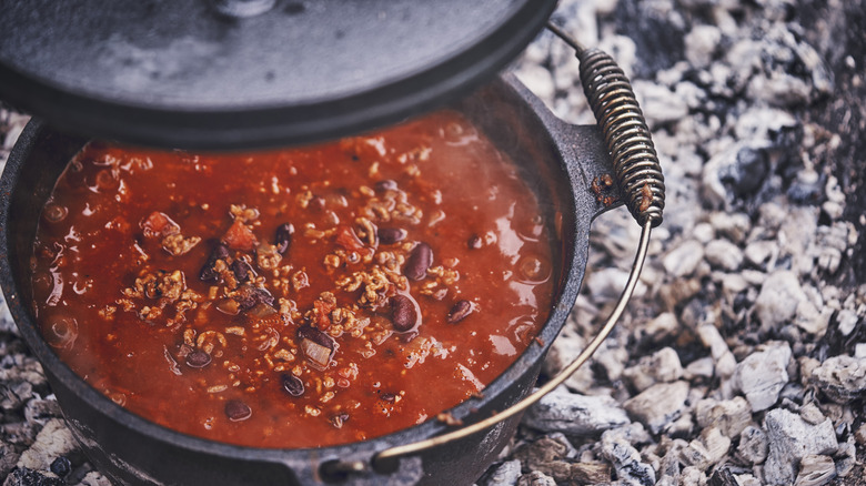 Chili in cast iron pot over coals