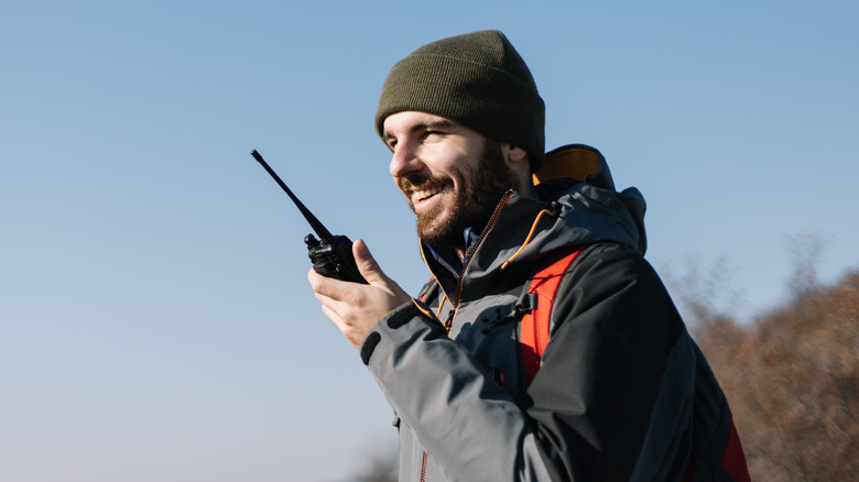Hiker using a walkie talkie 