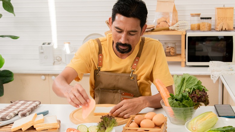 Man preparing sandwich at home