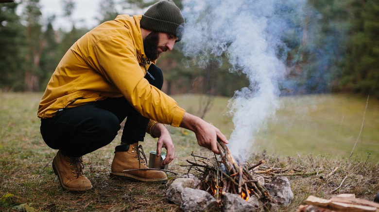 Man making an emergency campfire