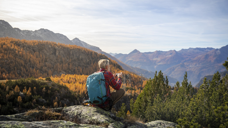 Hiker taking photo of autumn views