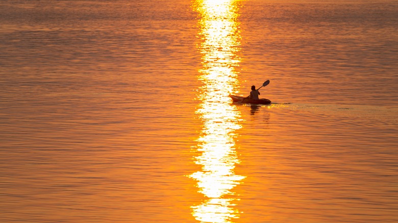 Kayak in water at sunset