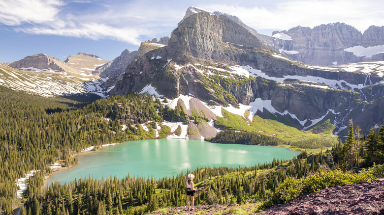 Hiker standing on top of cliff in Glacier National Park