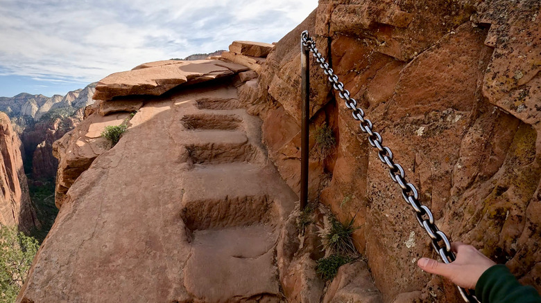 Hand holding railing along Angels Landing trail