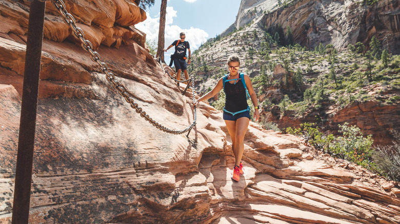 Two hikers on Angels Landing Trail, walking downhill