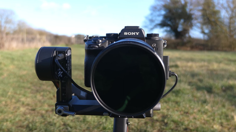 The Sony A1 camera with a lens on a tripod, front image