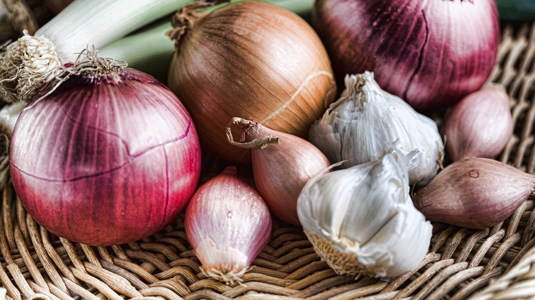 Members of the onion family in a basket