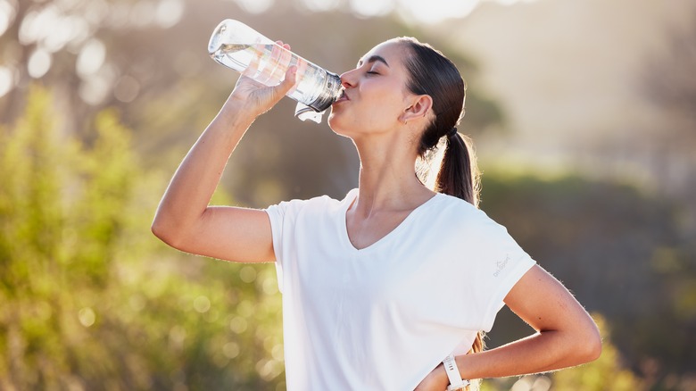 Happy woman drinking water 