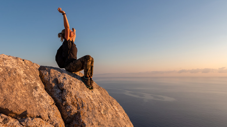 Accomplished hiker on cliff