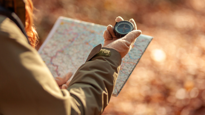 Hiker with map and compass