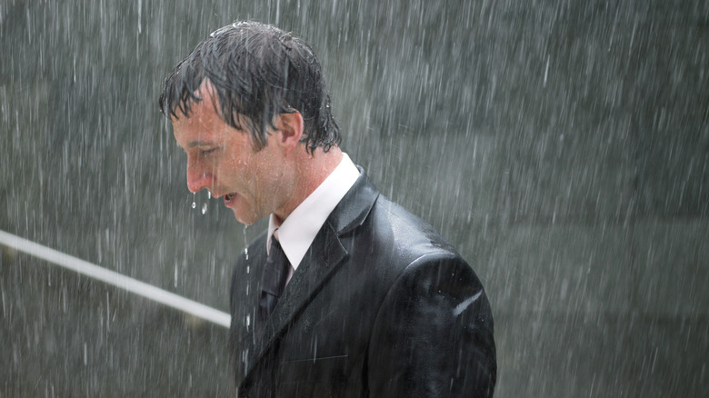 Man in suit standing in rain
