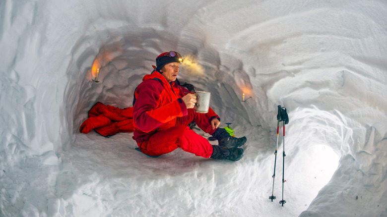Hiker in a makeshift snow cave