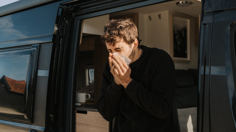 Sneezing man outside of RV