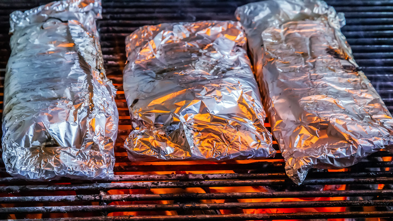 Food wrapped in foil on a grill