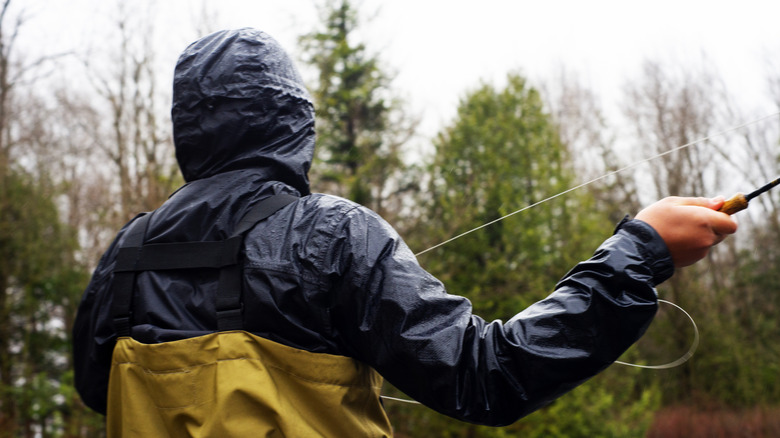 Fly fisherman fishing in the rain