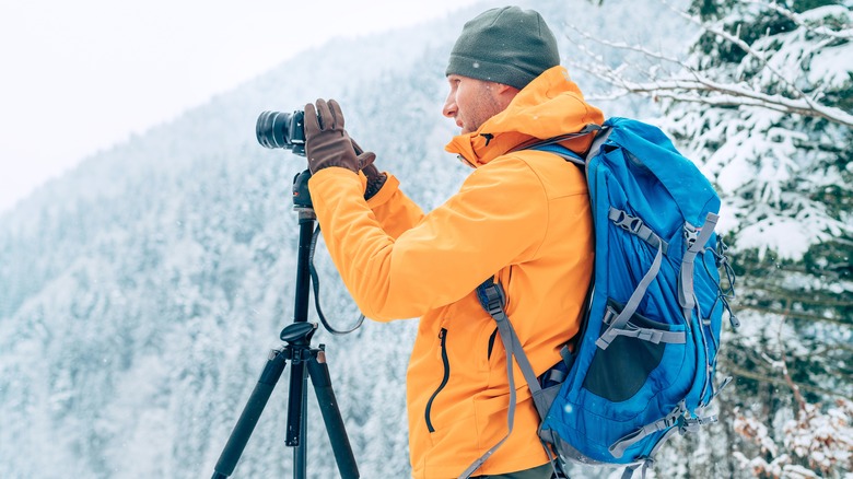 Hiker and photographer wearing orange