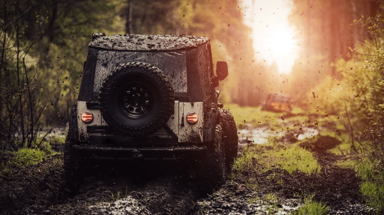 Off-roading car going through mud