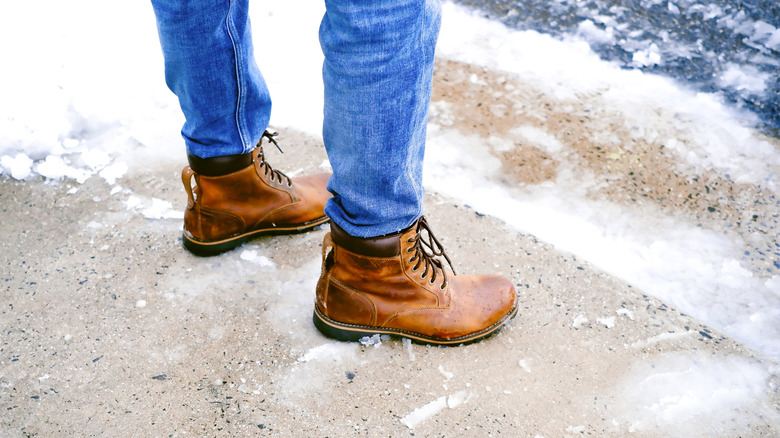 Feet standing on icy driveway